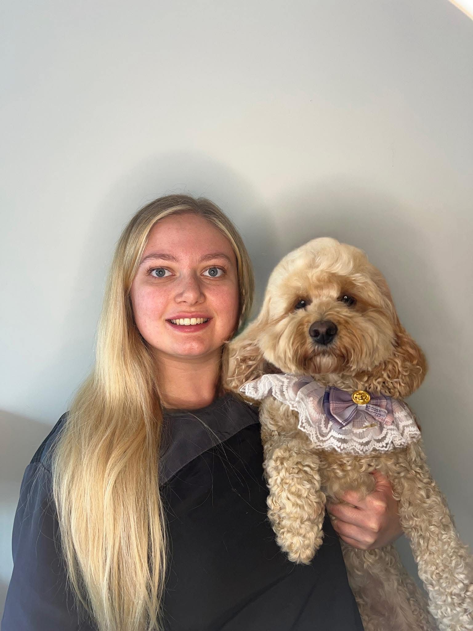 The Dolly and Co groomer holding a dog in Hockley